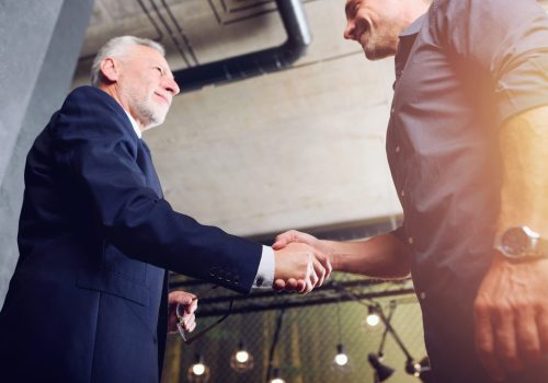 Handshaking business person in the office. concept of teamwork and business partnership.